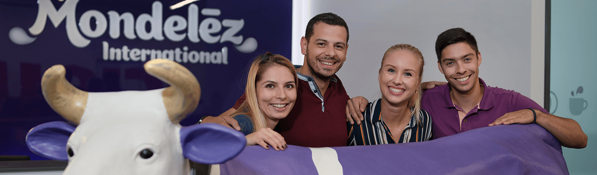 Team members smiling with cow